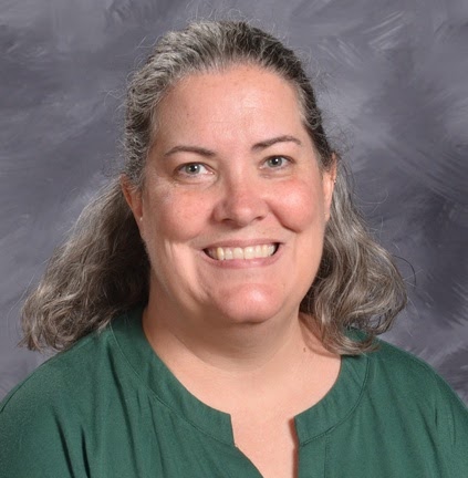 Smiling woman with shoulder-length gray hair