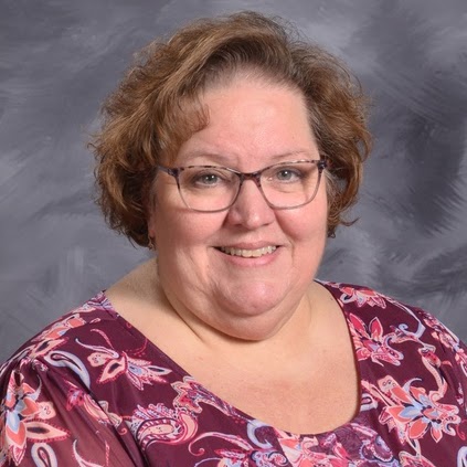 Smiling middle-aged woman with curly brown hair